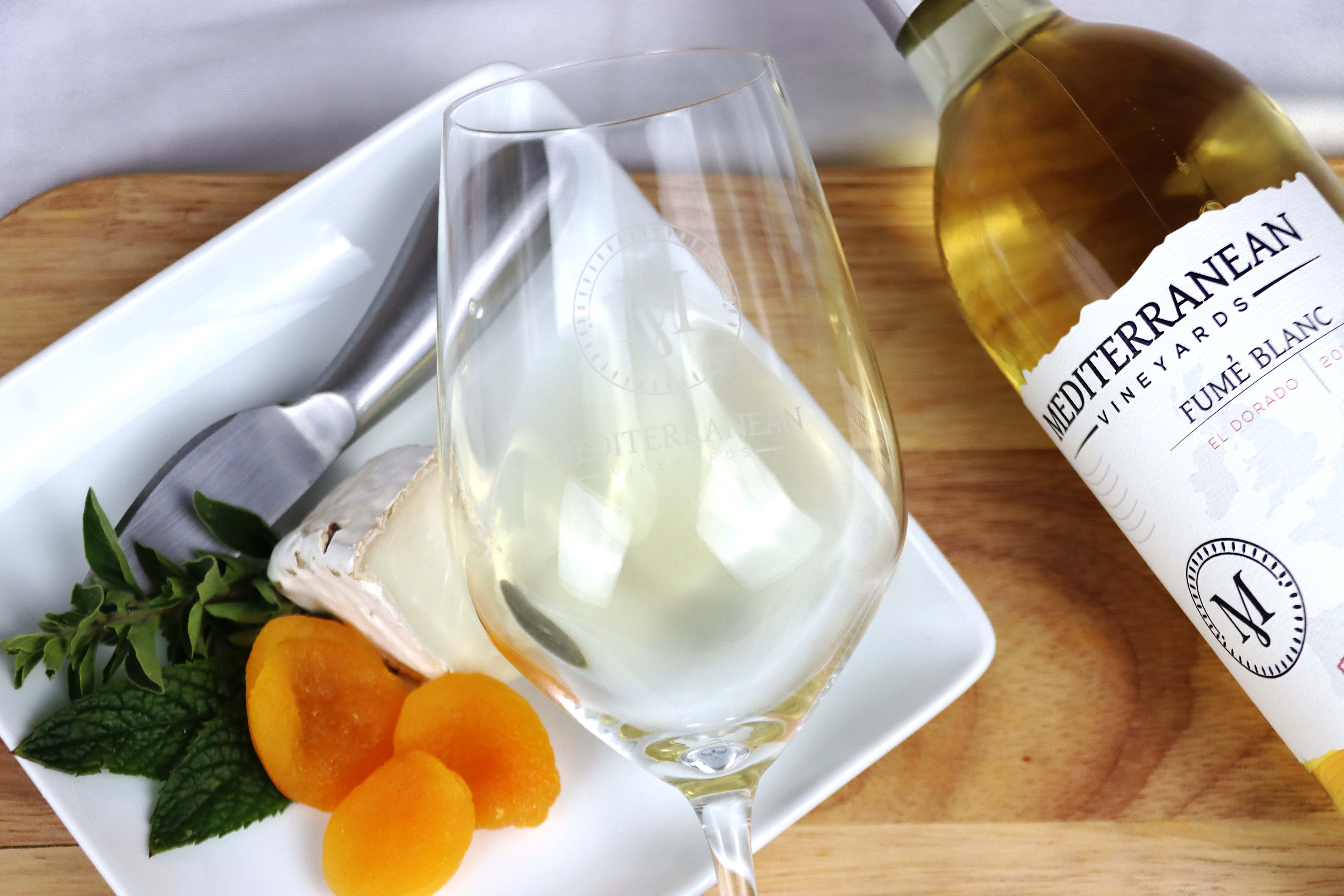 Brie cheese with apricot and fume blanc bottle