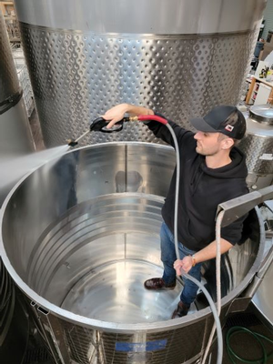Winemaker Taylor cleaning a tank during harvest